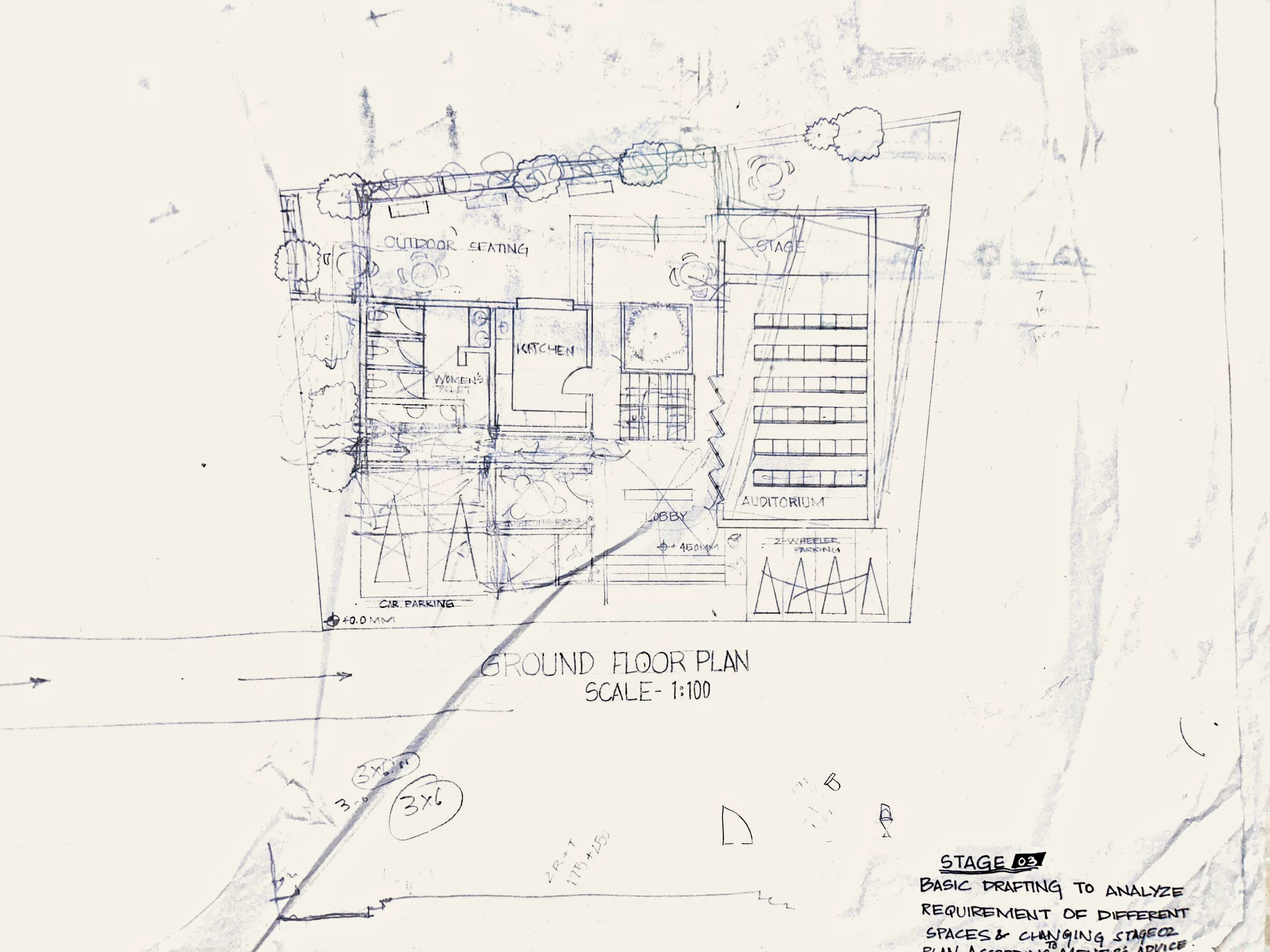 My ground floor plan at 1:100 in pencil: car parking, kitchen, outdoor seating, a courtyard and an auditorium with rows of seats, drawn over the site lines.